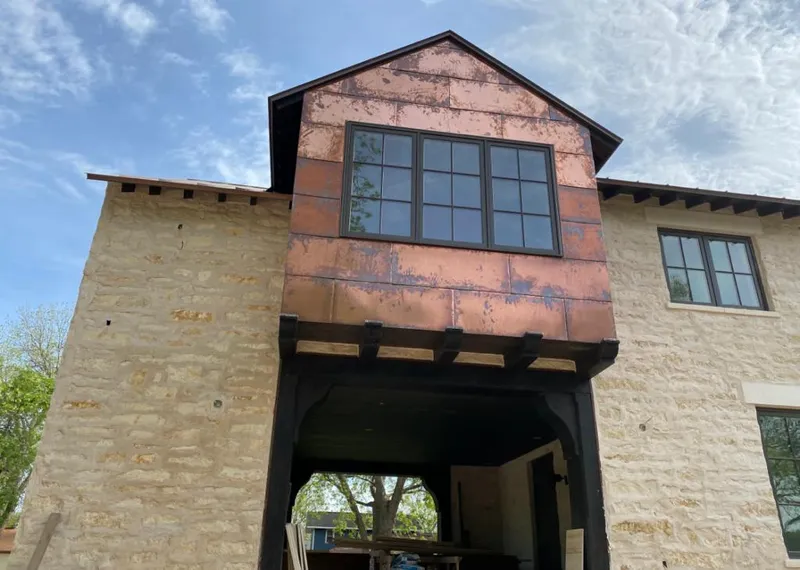 Copper metal panel facade on a stone building for Roof Repair in Millersville